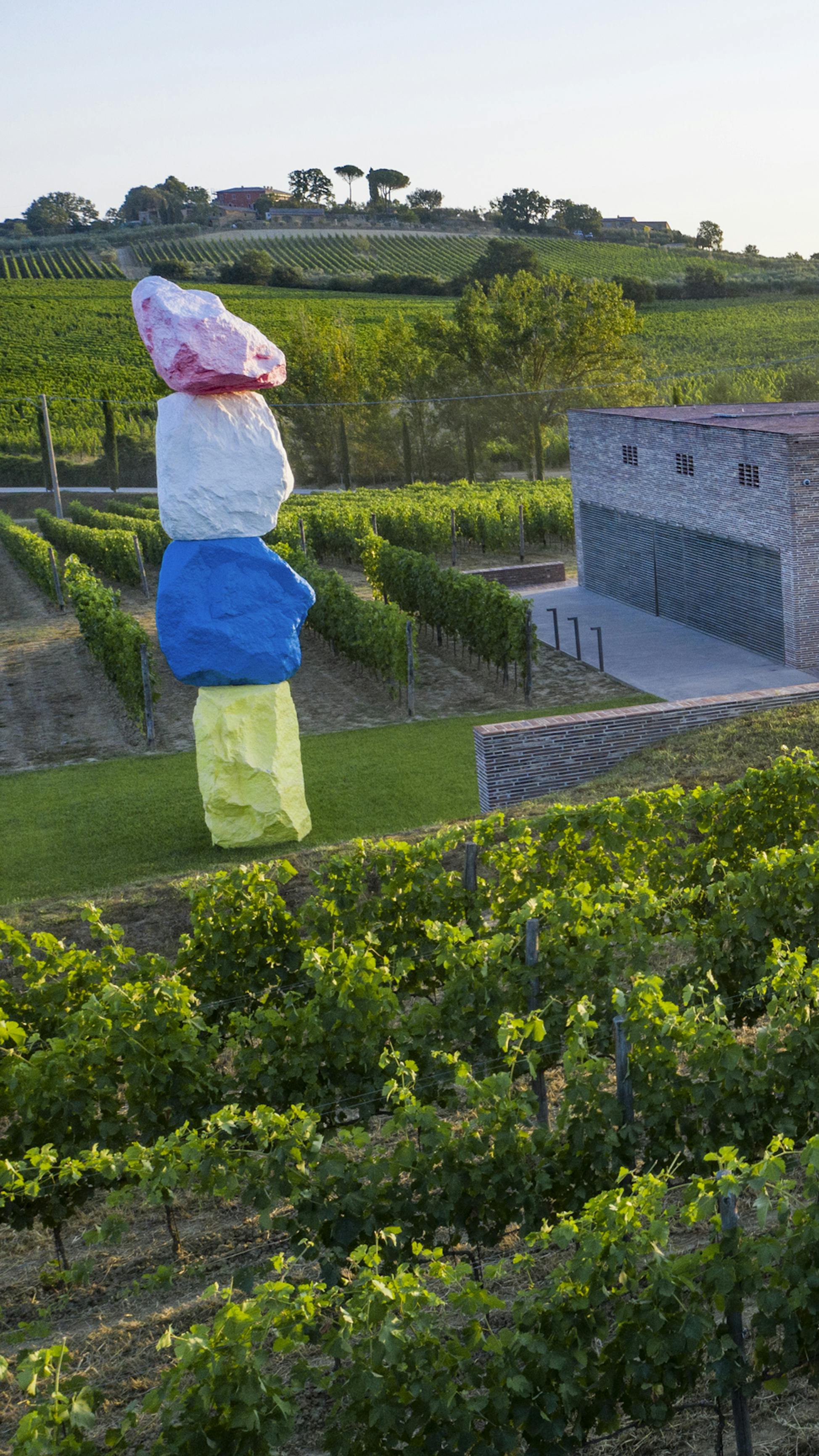 View on Fabbrica winery with colourful sculpture of Ugo Rondinone and vineyards